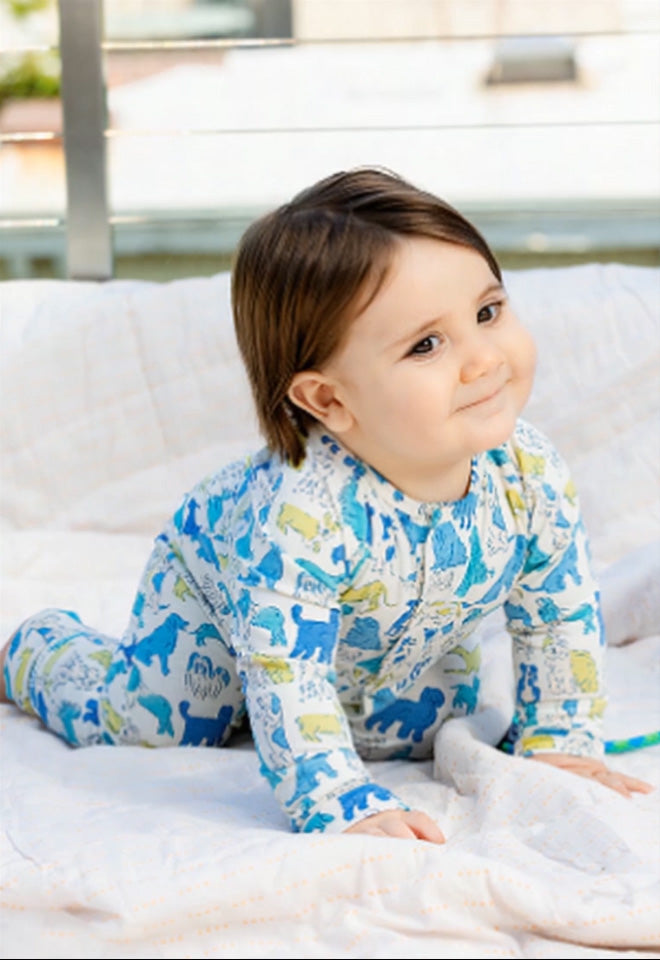 Baby wearing a Convertible Coverall. Button leads to the  Convertible Coverall collection page.