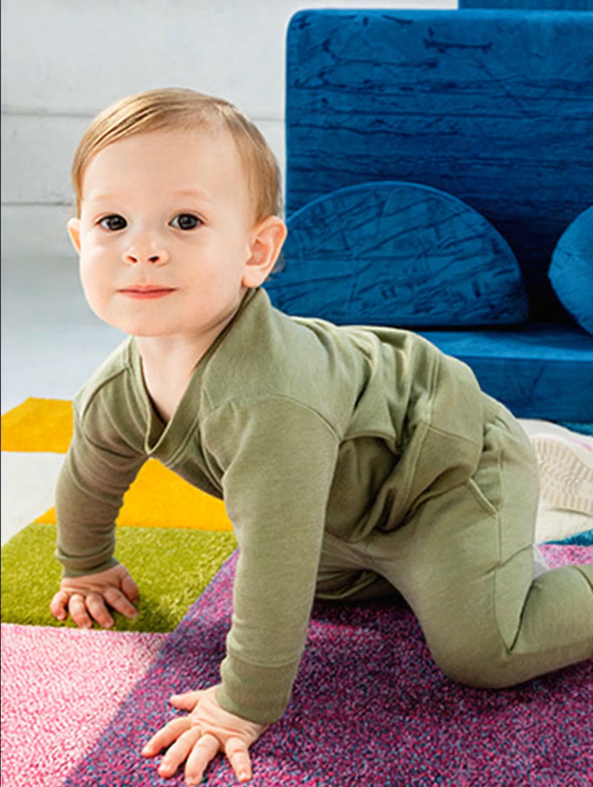 Baby wearing a sweatsuit set. Button leads to the Daywear collection page.