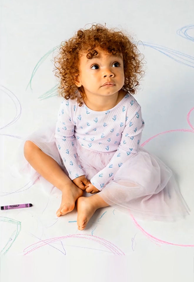 Toddler wearing a dress. Button leads to the Dress collection page.
