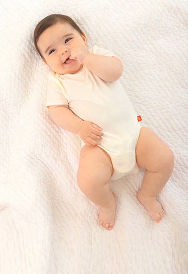 Baby wearing a Bodysuit. Button leads to the Bodysuit collection page.