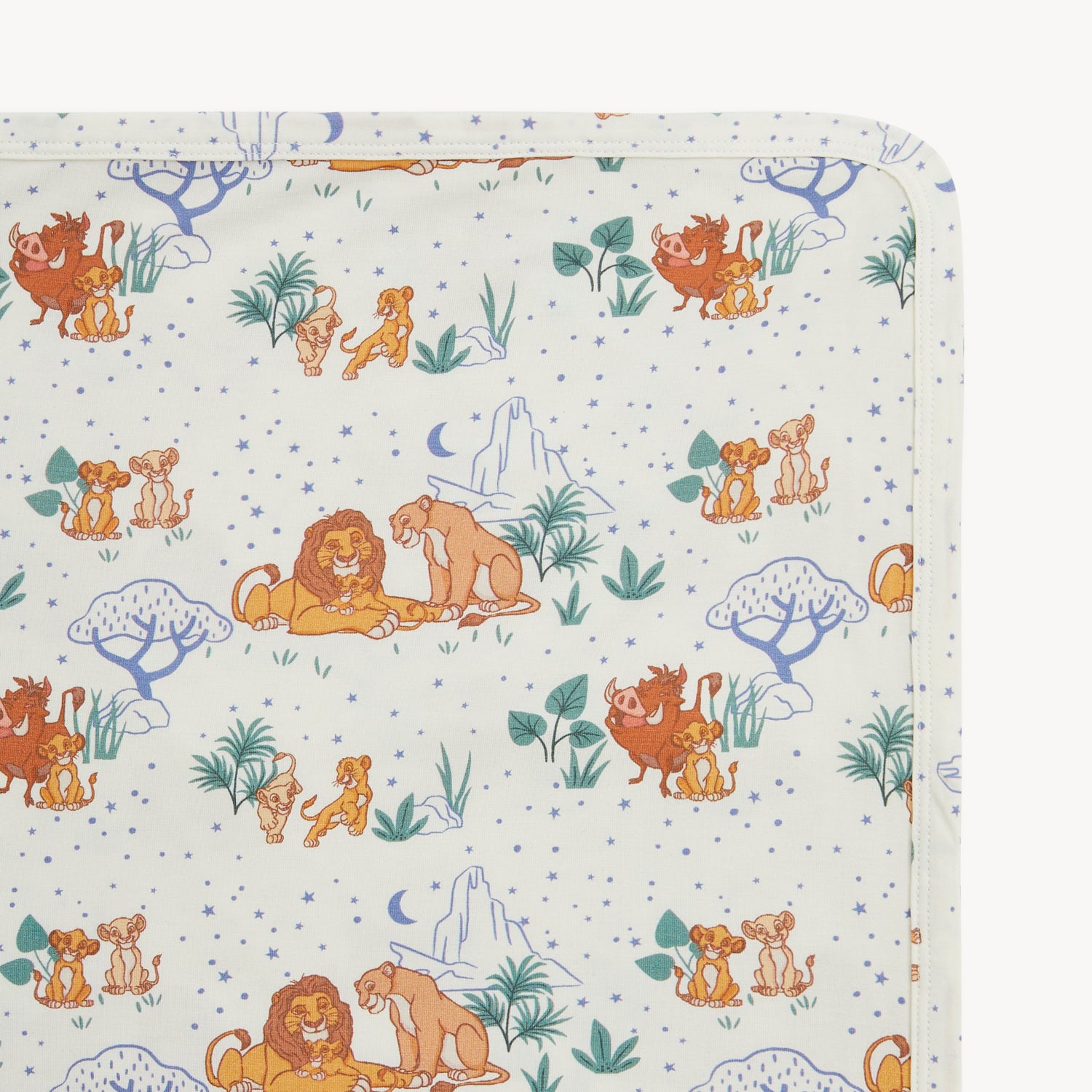 Close up photo of A 30" x 30" cream-colored baby blanket featuring a dense repeating pattern of Disney Lion King characters, tropical greenery, and blue celestial elements by Magnetic Me.