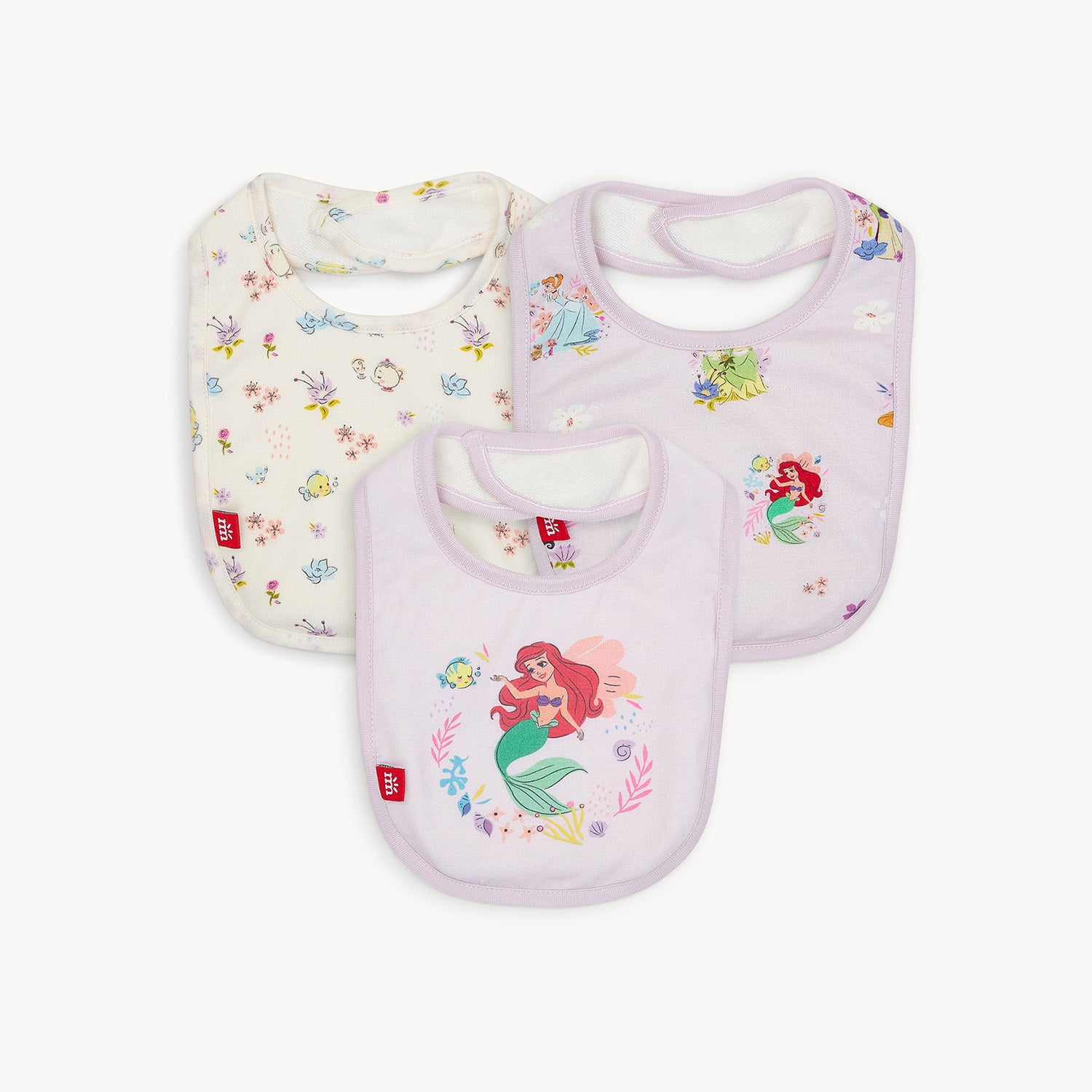 This three-pack of infant bibs includes one cream bib featuring a Disney Princess Friends print and two lavender bibs, one with an all-over Disney Princess pattern and one with a large central Ariel graphic, by Magnetic Me.