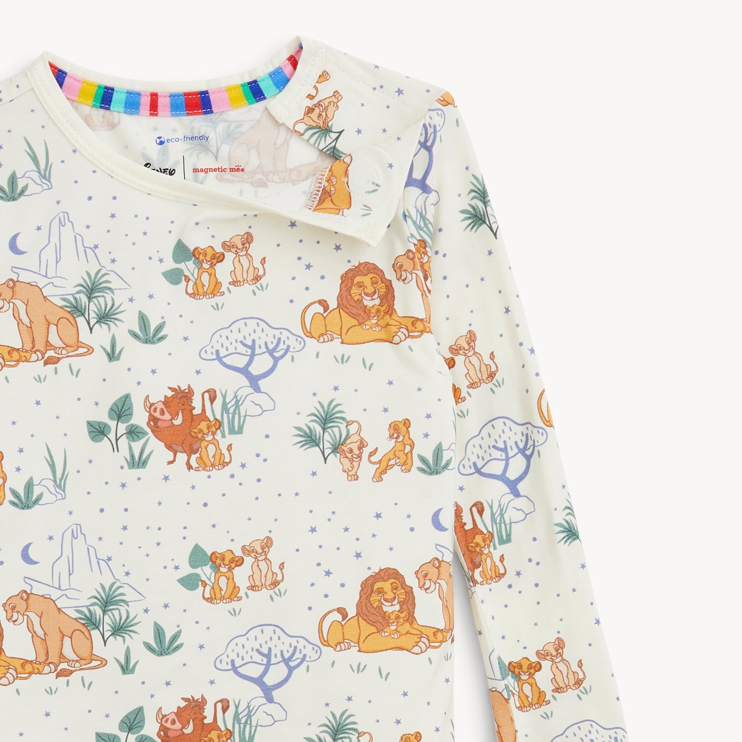 Open magnet on the shoulder area of A two-piece pajama set in cream fabric featuring a long-sleeve top and matching pants with an all-over print of Disney Simba and his friends by Magnetic Me.