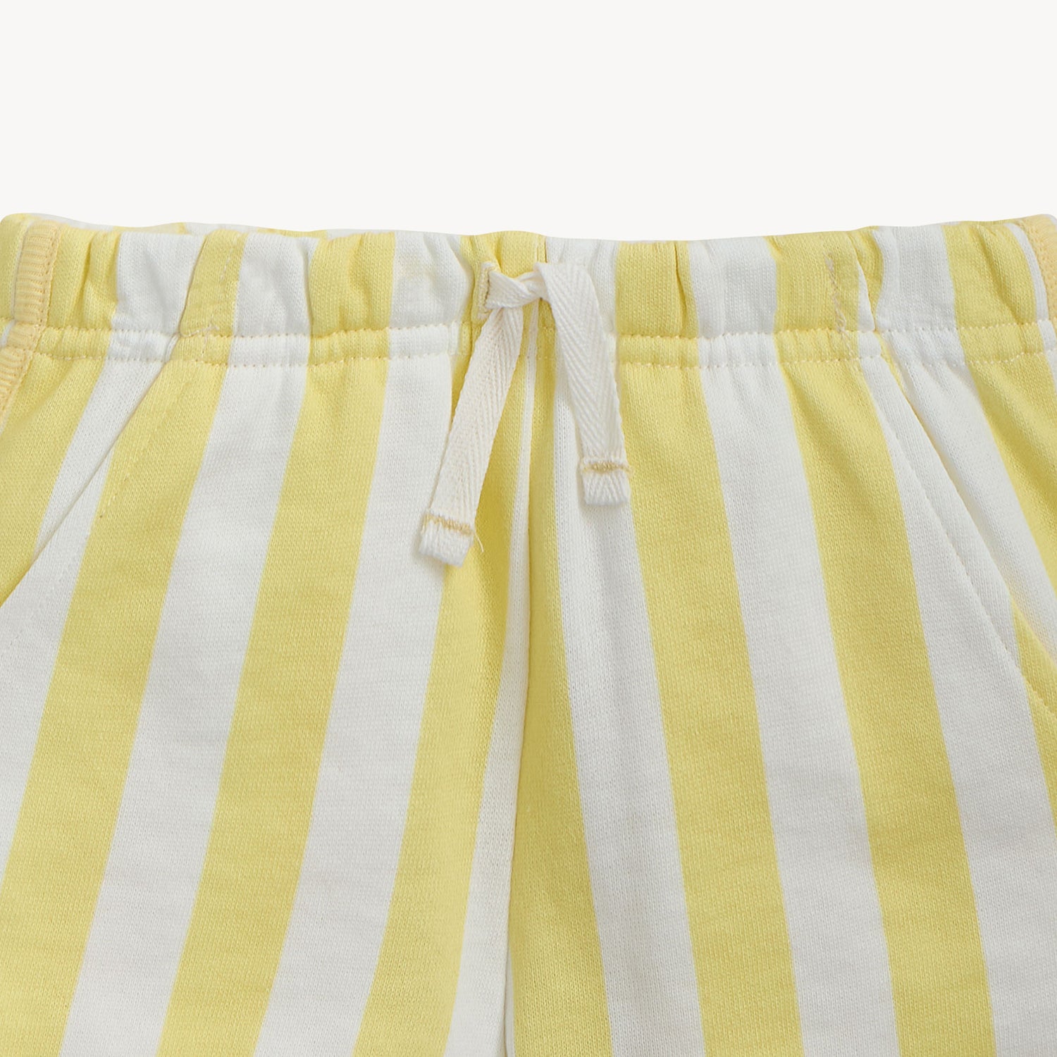 Close-up of yellow and white striped shorts with drawstring on by Magnetic Me.