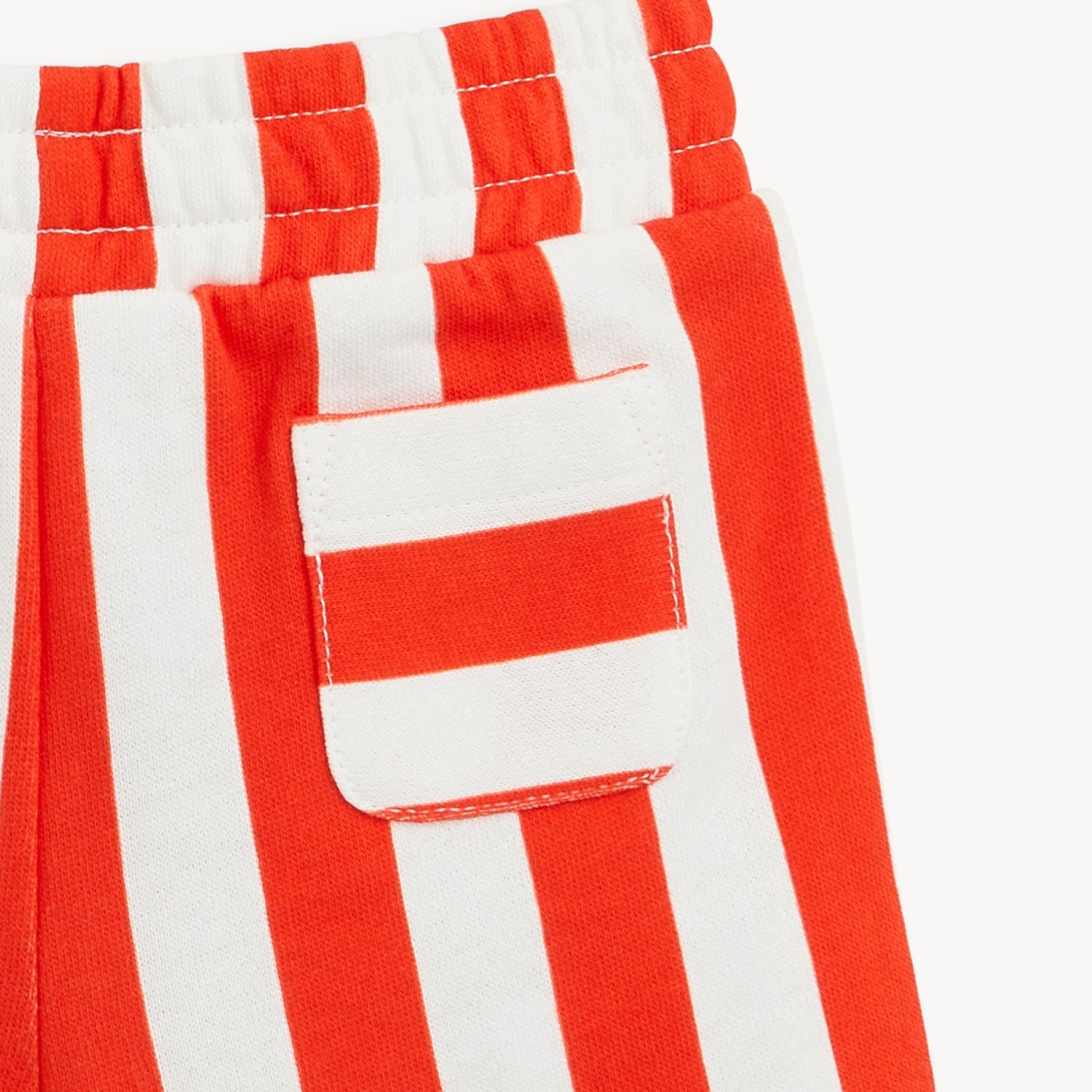 Close-up of red and white striped pants with a pocket by Magnetic Me.