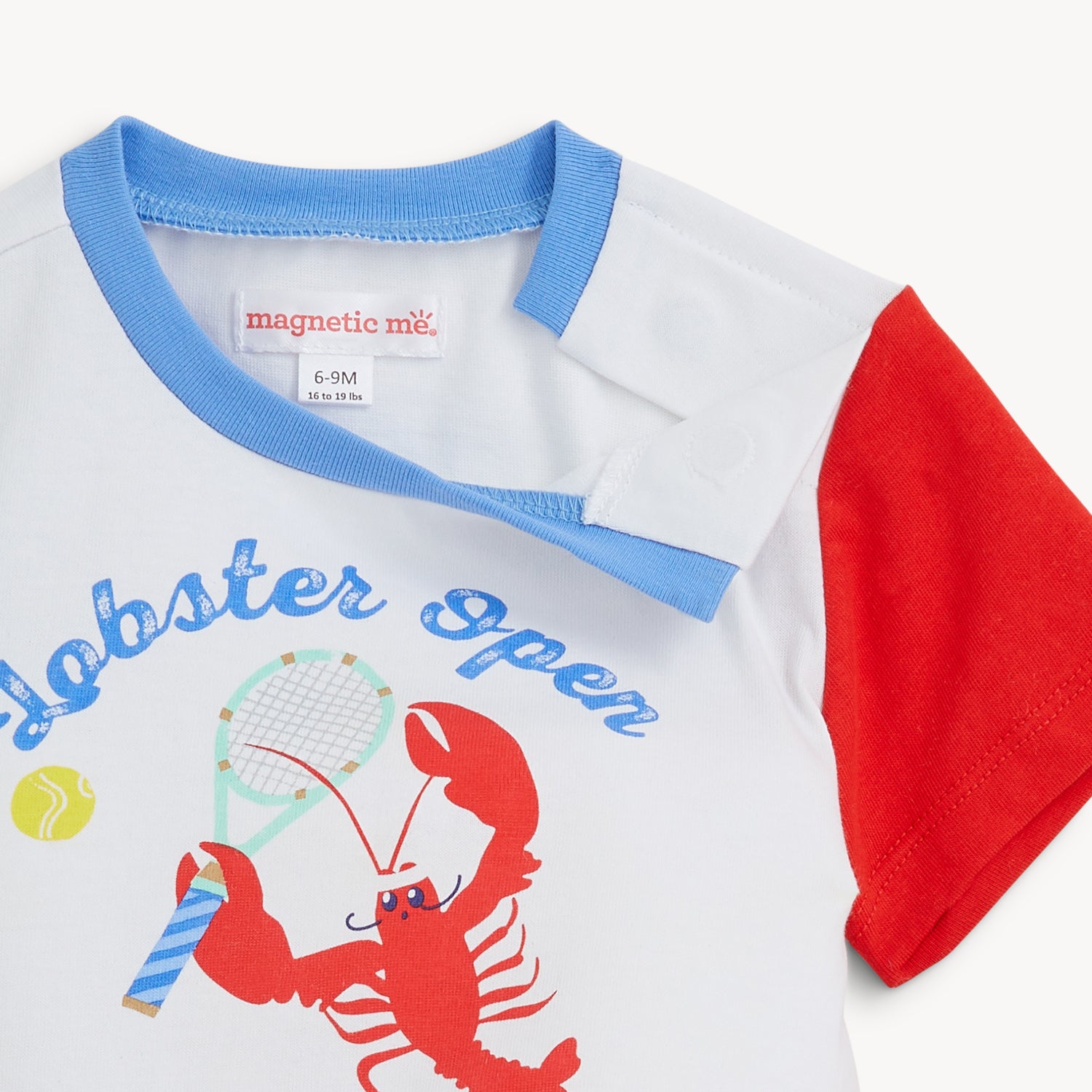 Open magnet on the shoulder of the color-block tee with a lobster playing tennis by Magnetic Me.