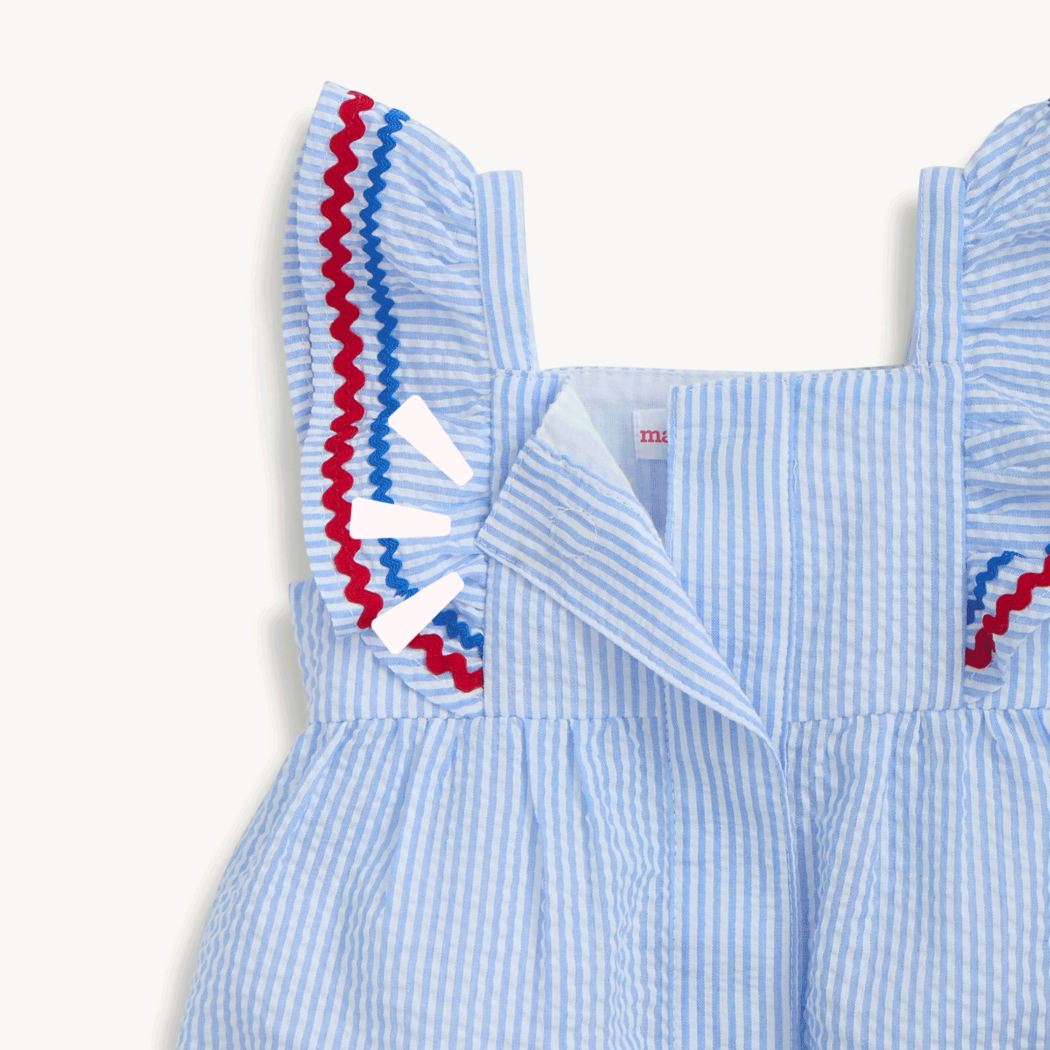 Open and close magnet in the upper back of the light blue striped seersucker sleeveless dress featuring ruffled straps and a tiered hem detailed with red and blue rickrack trim, by Magnetic Me.