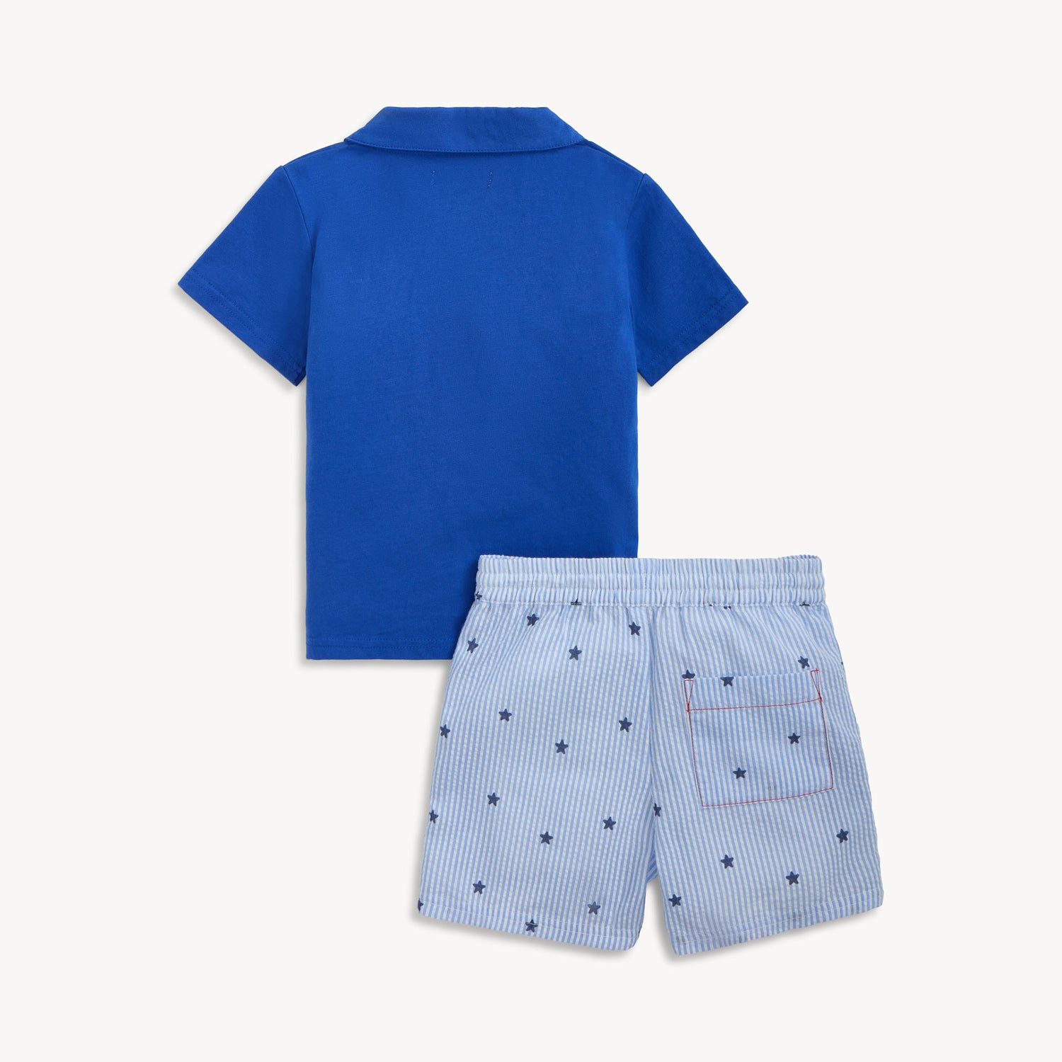 Back of the two-piece set featuring a solid royal blue short-sleeve polo shirt paired with light blue striped seersucker shorts with navy star embroidery, by Magnetic Me.