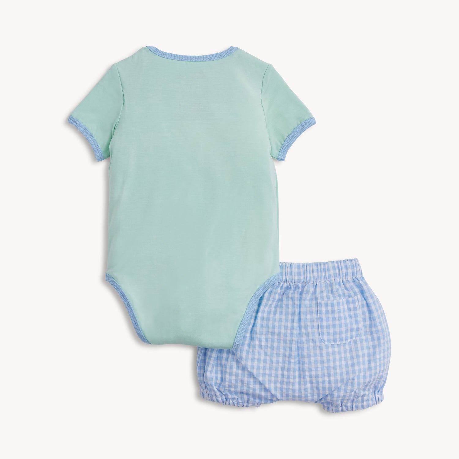Back of the two-piece set featuring a light green short-sleeve bodysuit with blue trim and matching blue gingham bloomers with a functional back pocket, by Magnetic Me.