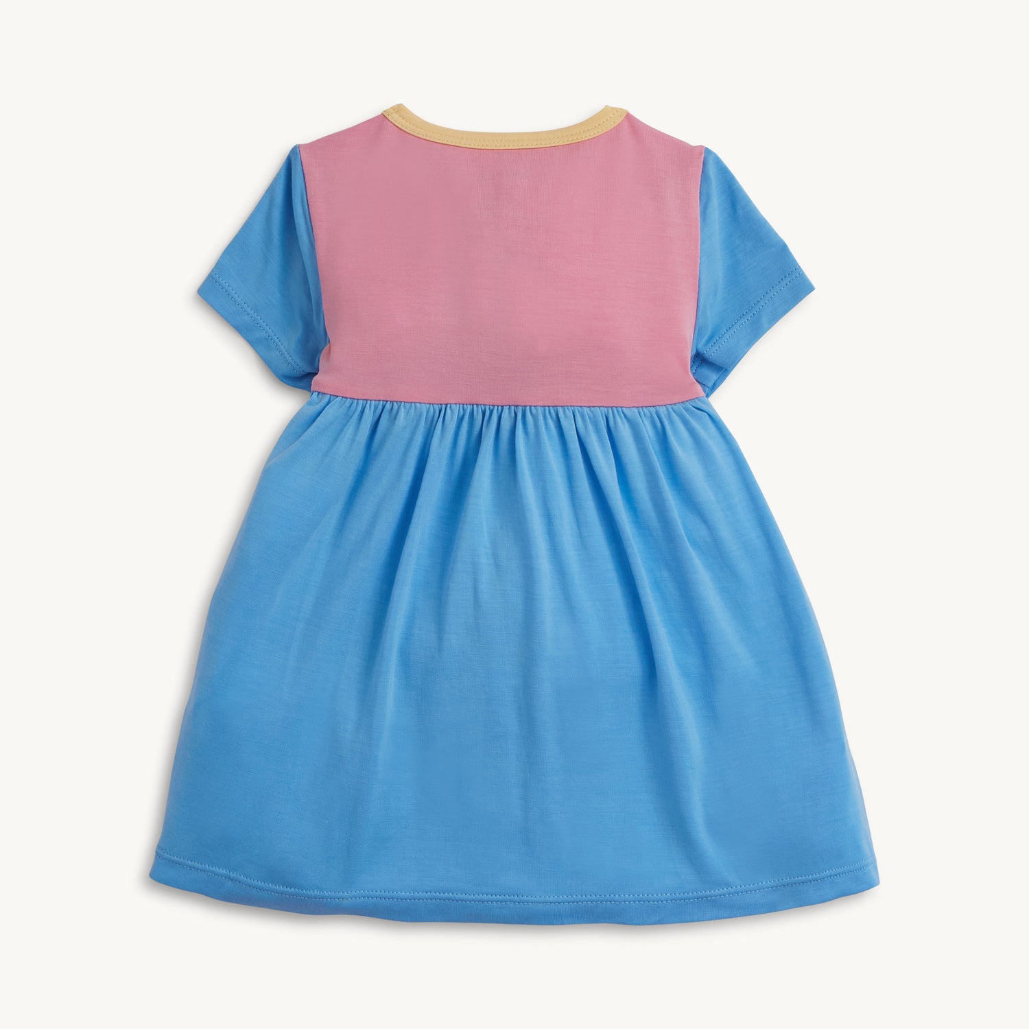 Back of the A short-sleeve bodysuit dress featuring a pink bodice with blue sleeves and a yellow chest pocket, a blue gathered skirt, and a solid pink back, by Magnetic Me.
