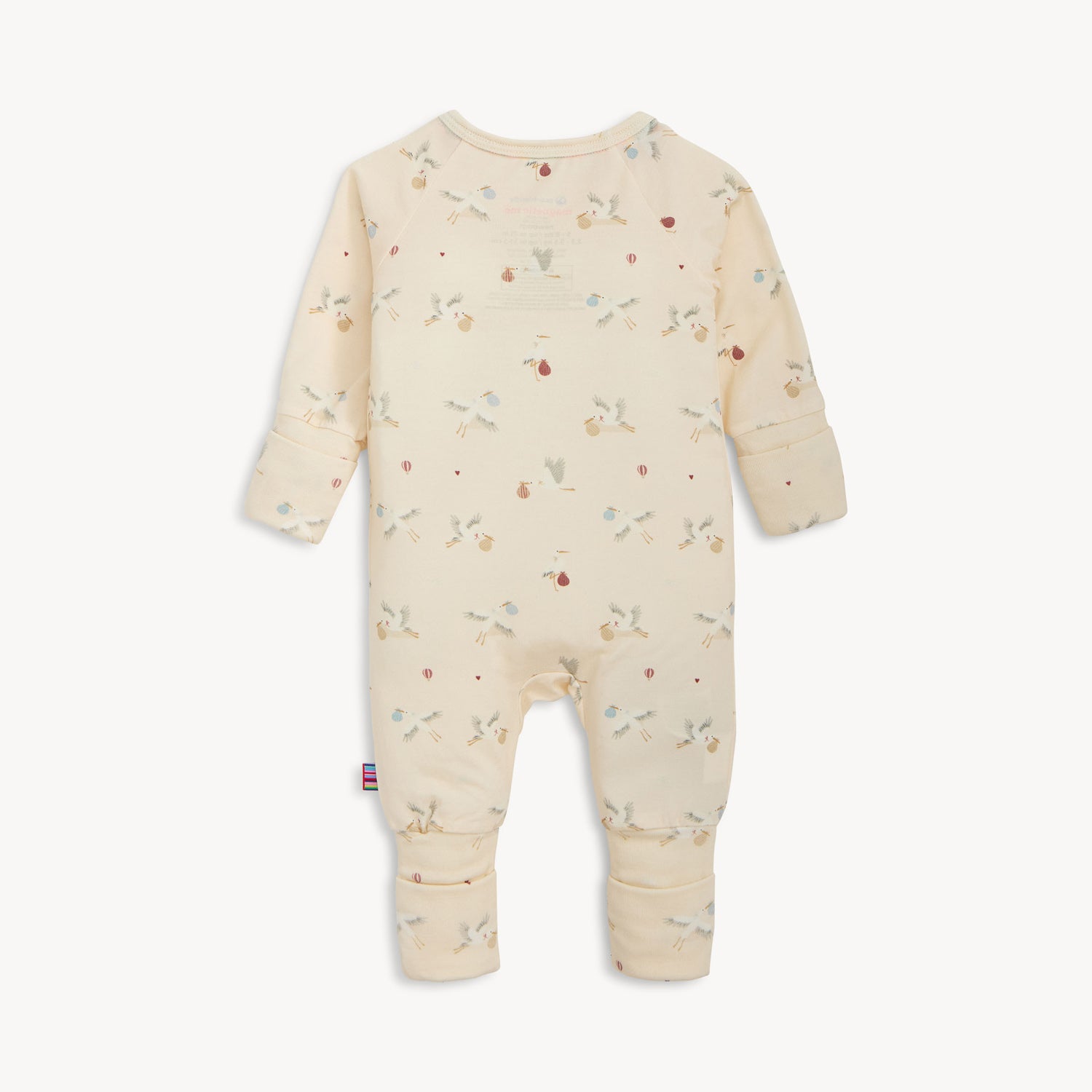 back of cream-colored long-sleeve convertible coverall with a repeating pattern of storks and hot air balloons, by Magnetic Me.