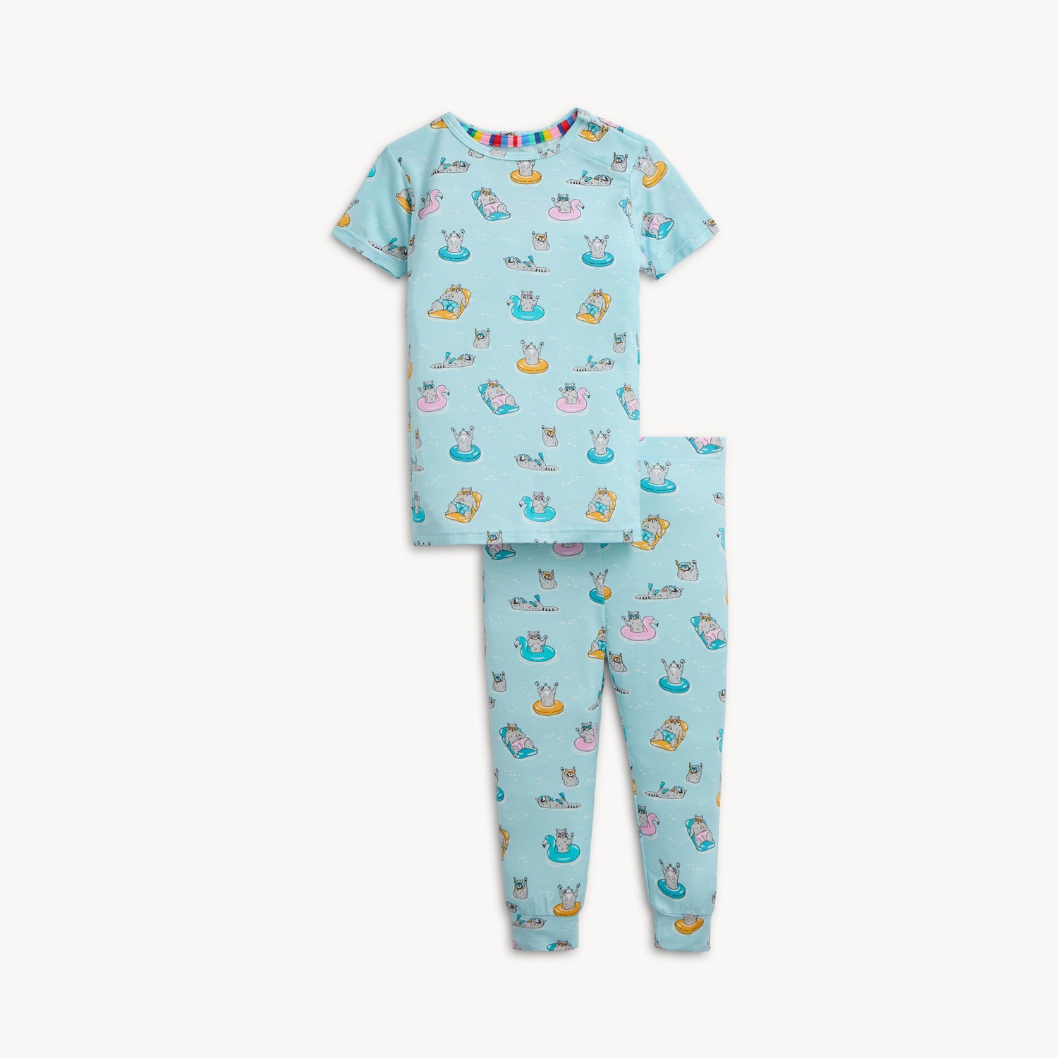 A two-piece pajama set in light blue featuring a repeating print of raccoons on bright pool floats and wearing goggles, by Magnetic Me.