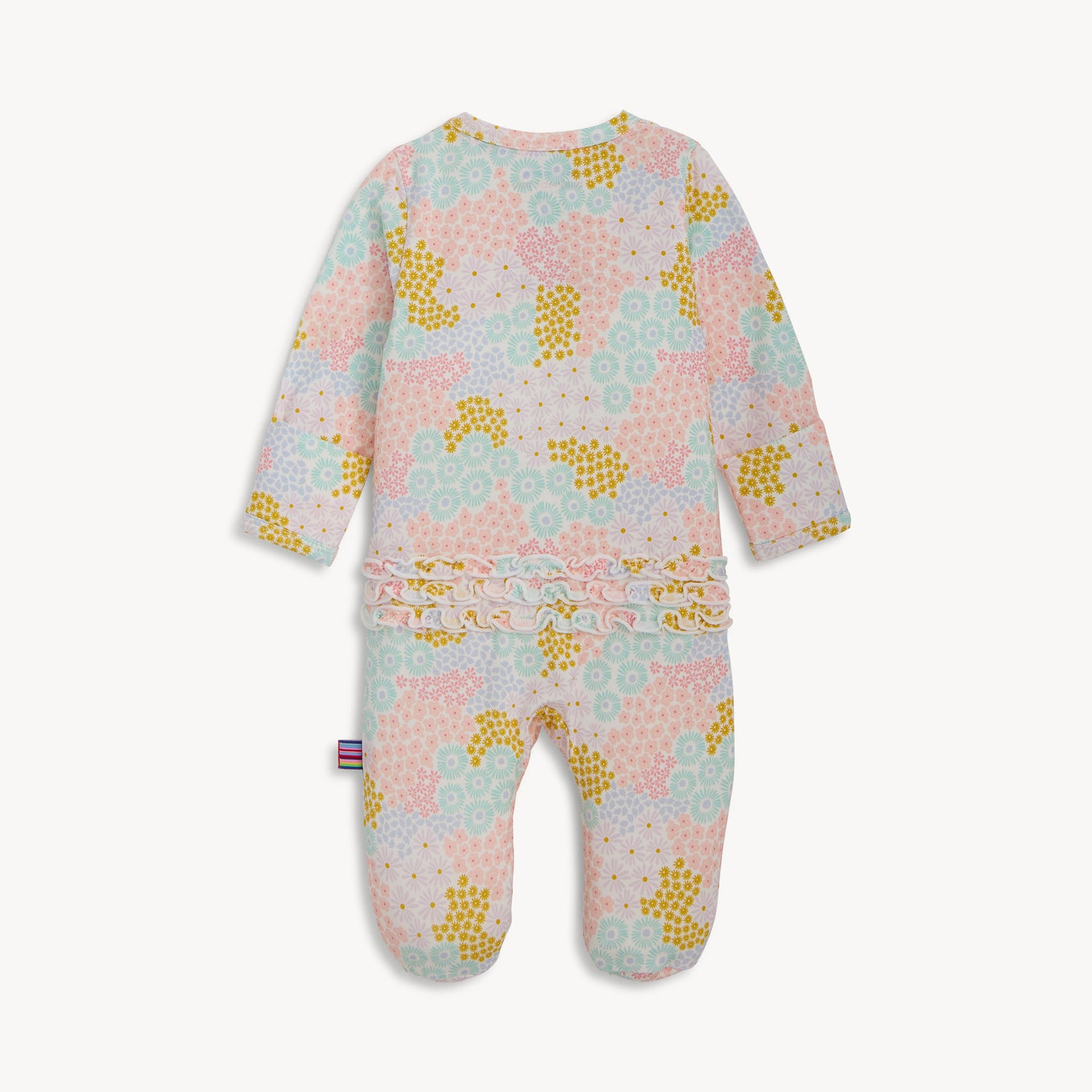 Back of A long-sleeve footie with a vertical ruffle along the zipper featuring a dense print of pink, purple, and blue wildflowers on white fabric, by Magnetic Me.
