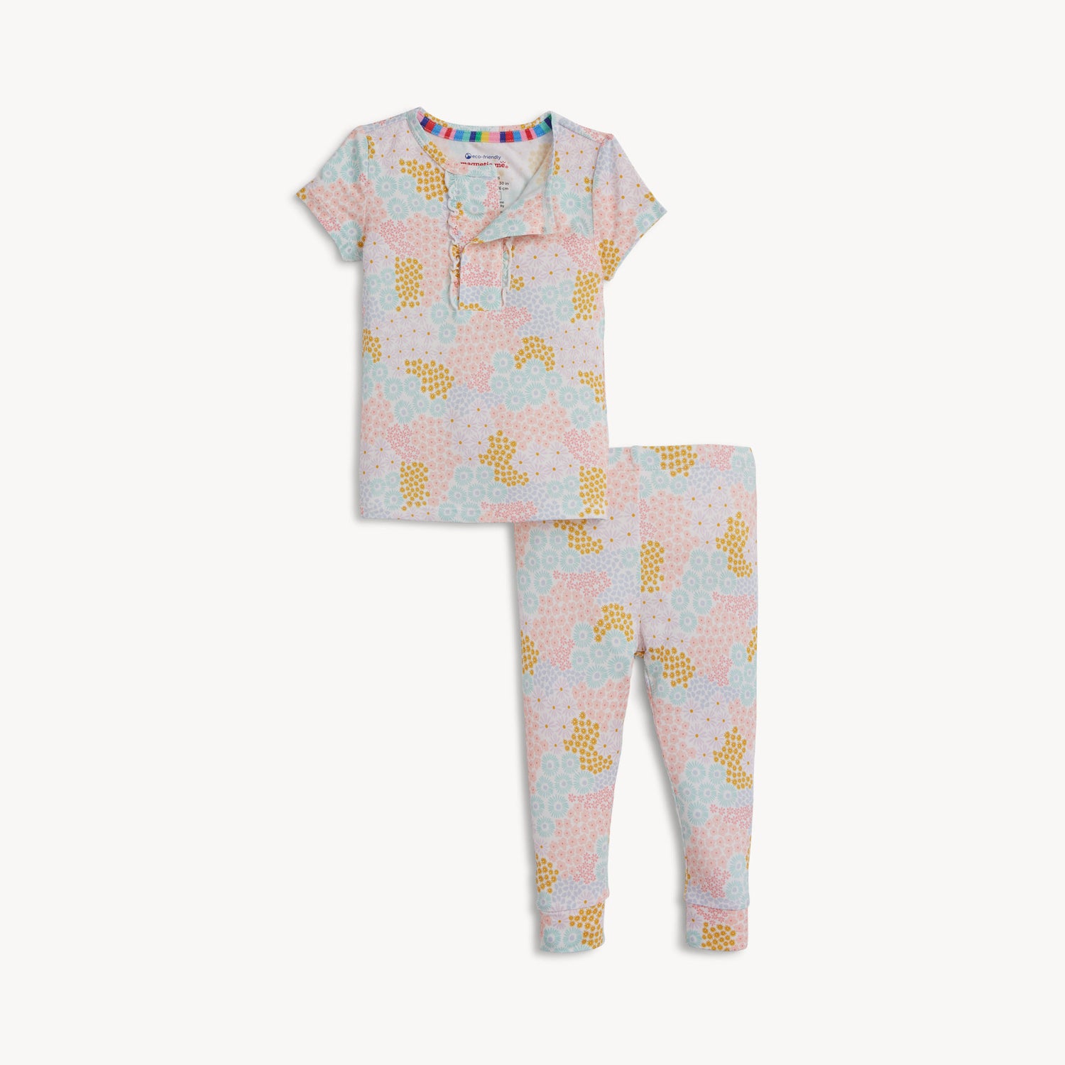 A two-piece pajama set featuring a short-sleeve ruffle-trim top and matching pants in a bright pastel spring floral print, by Magnetic Me.
