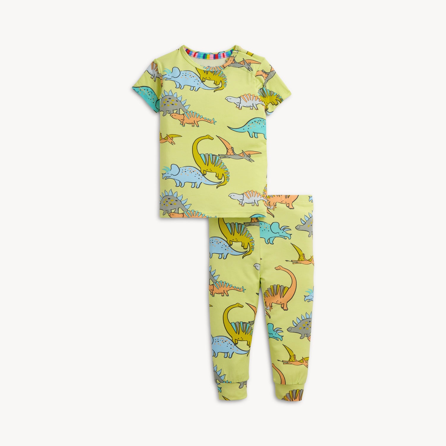 A two-piece pajama set with a short-sleeve top and long pants in lime green fabric covered in a whimsical dinosaur print, by Magnetic Me.