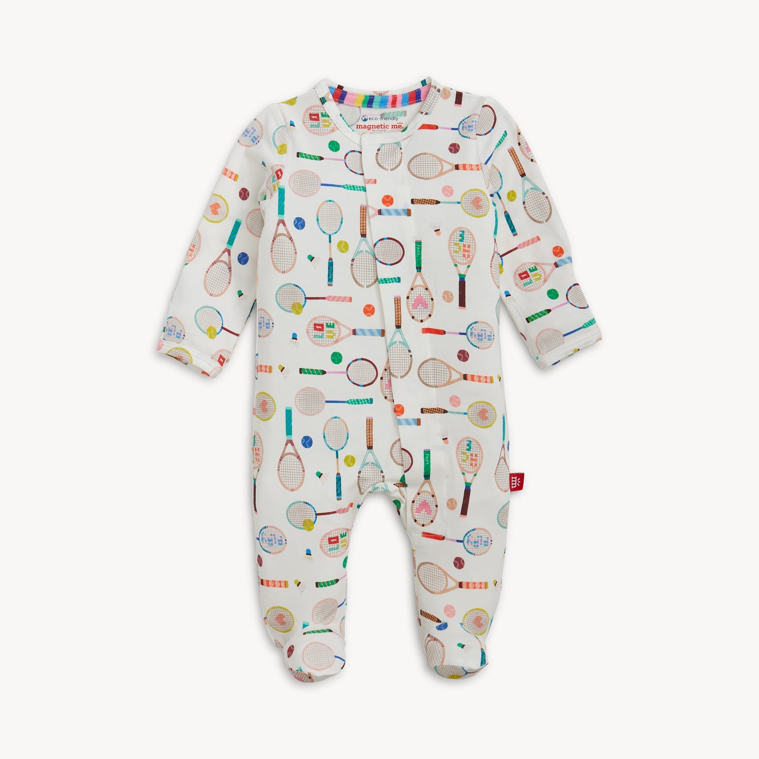 A long-sleeve cream footie featuring a playful, multi-colored pattern of tennis rackets, balls, and badminton shuttlecocks, by Magnetic Me.