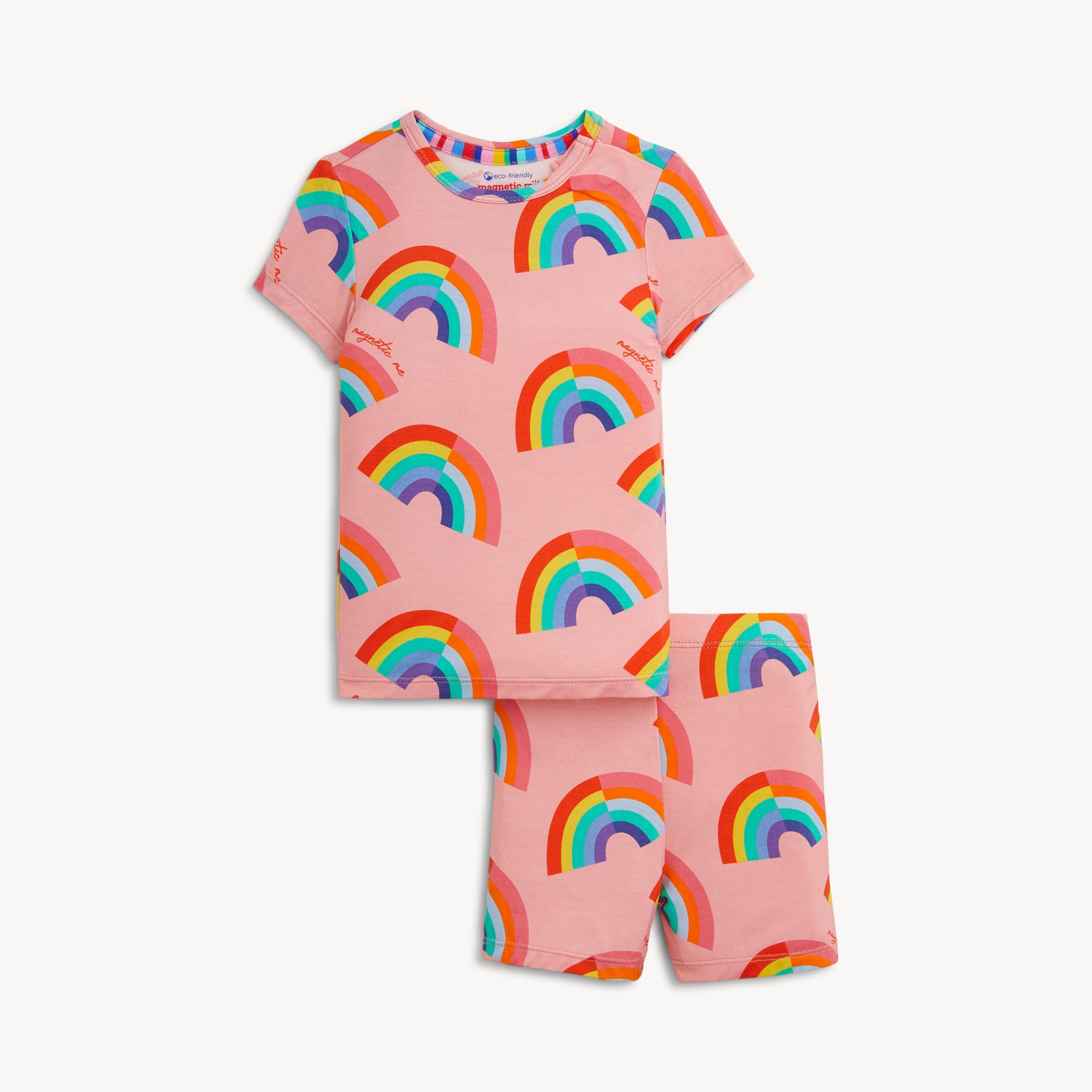 A two-piece pajama set with a short-sleeve top and matching shorts in pink fabric featuring a bright, repeating rainbow pattern, by Magnetic Me.