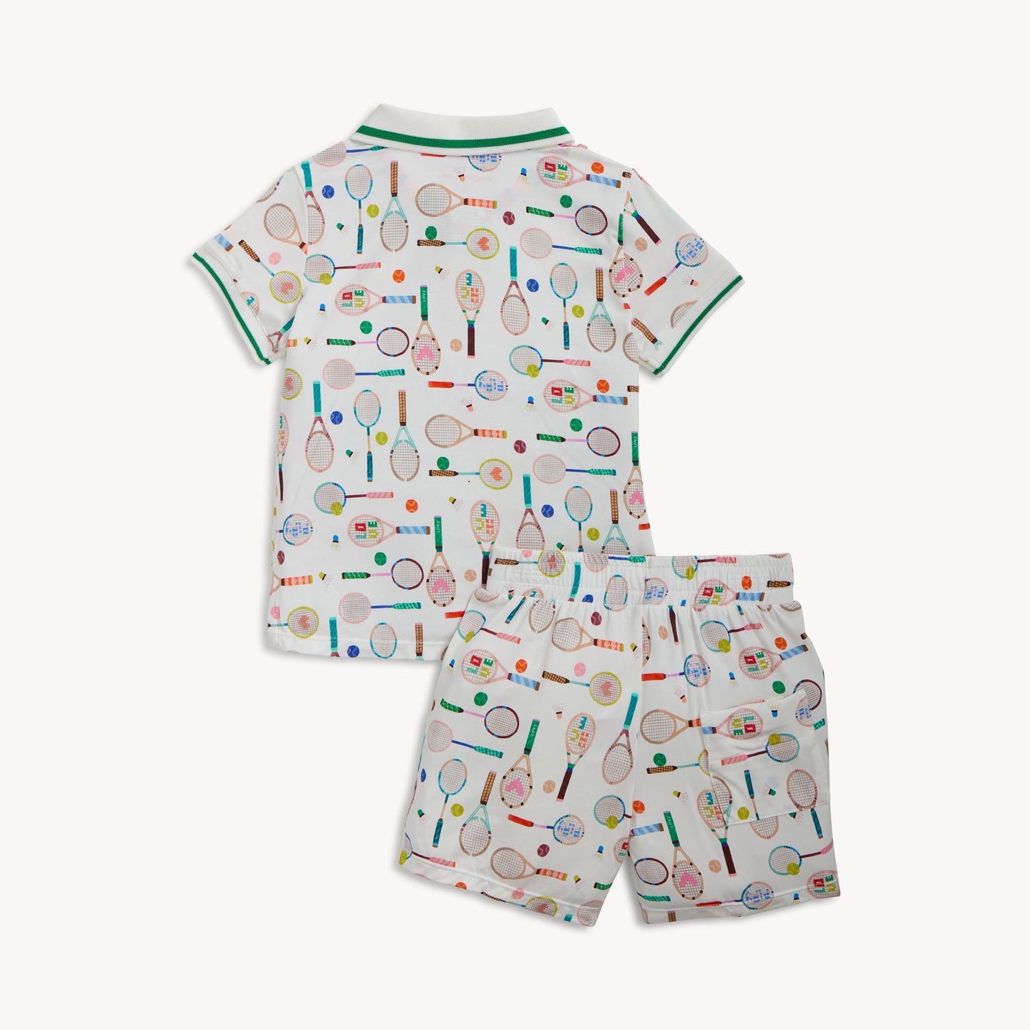 Back of A two-piece set including a cream polo-style short-sleeve top and matching shorts with a vibrant tennis-themed equipment print, by Magnetic Me.