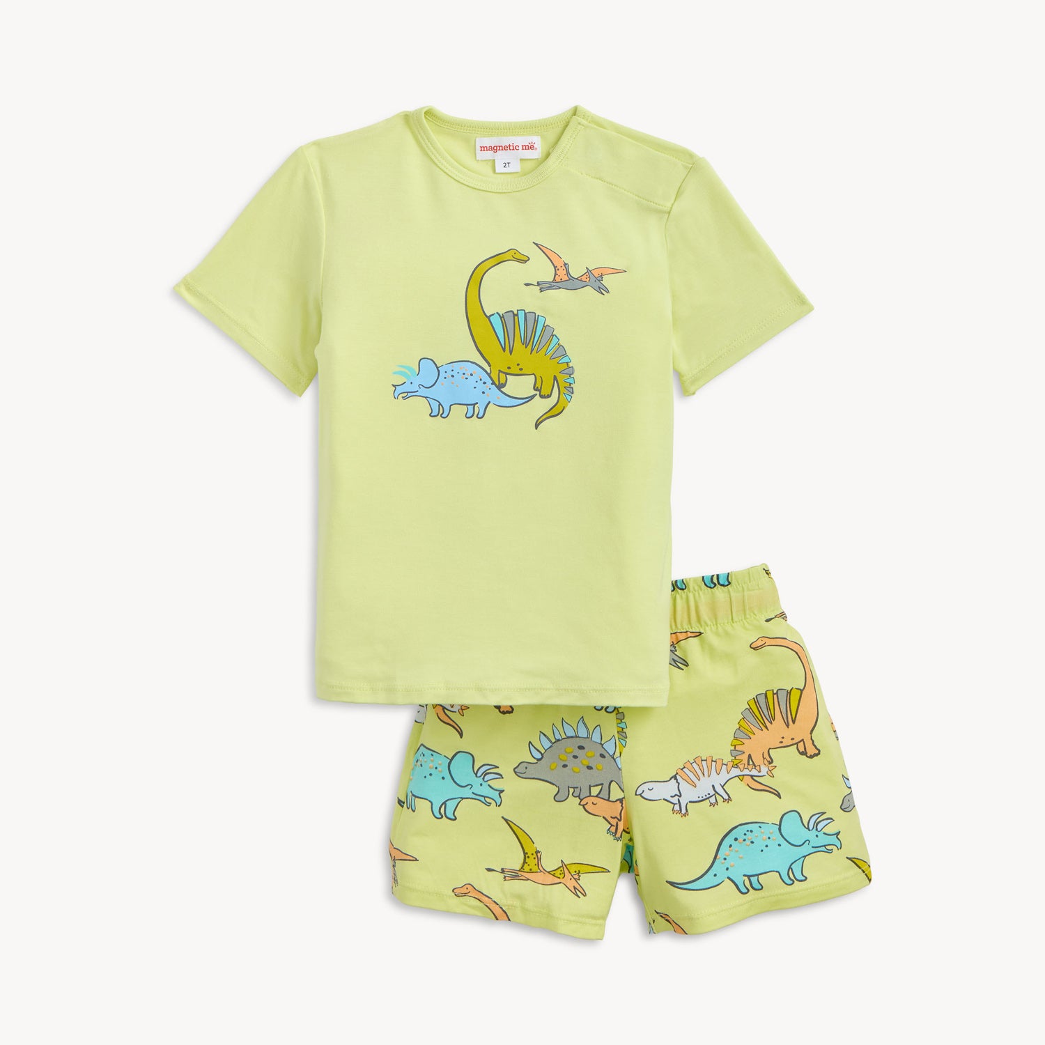 A two-piece pajama set with a short-sleeve top and long pants in lime green fabric covered in a whimsical dinosaur print, by Magnetic Me.