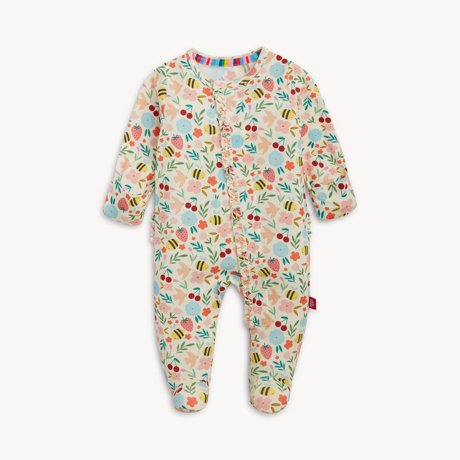 A long-sleeve baby footie featuring a garden print of bees and fruit with a ruffled magnetic closure and integrated scratch mittens, by Magnetic Me.