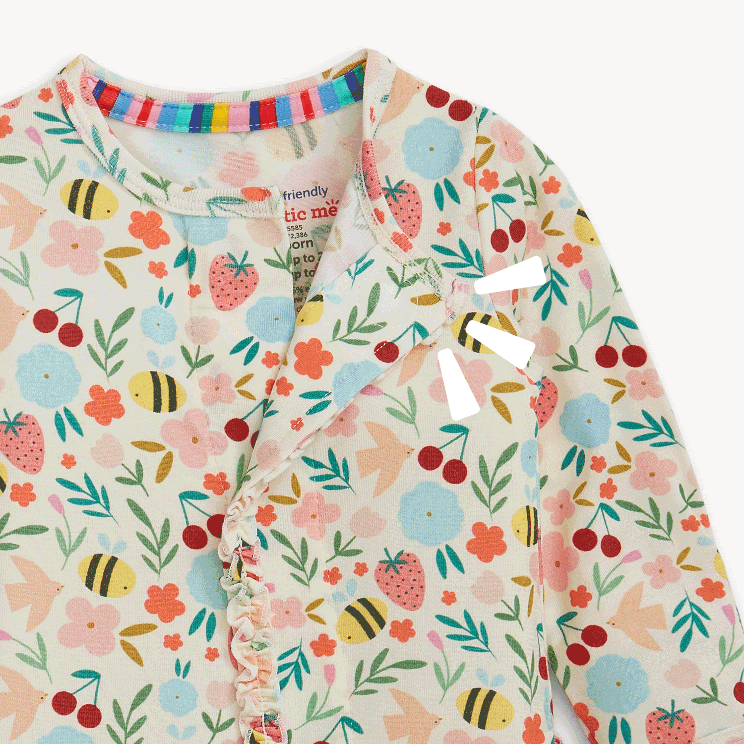 Open and closing magnet on A long-sleeve baby footie featuring a garden print of bees and fruit with a ruffled magnetic closure and integrated scratch mittens, by Magnetic Me.