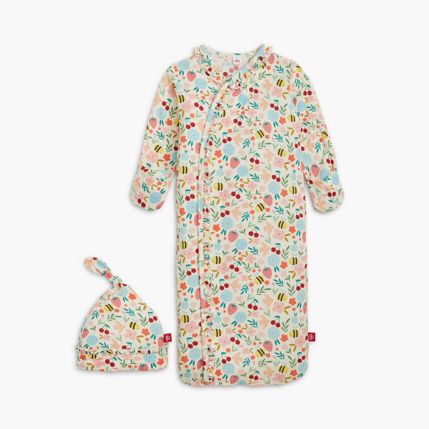 A long-sleeve baby gown and matching knotted hat set featuring a garden print of bees, birds, and flowers with a ruffled magnetic closure, by Magnetic Me.