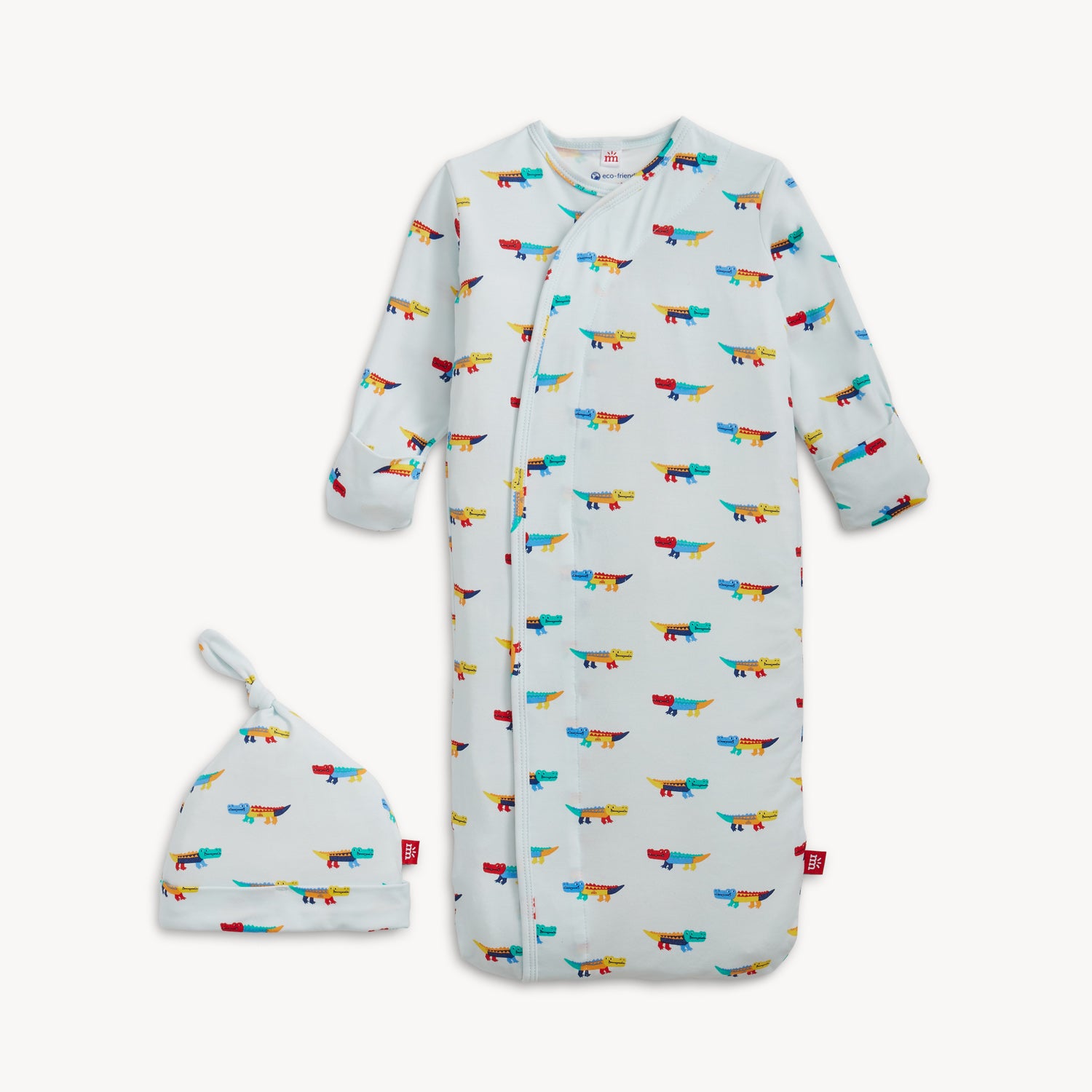 A cozy sleeper gown and matching knotted hat set in light blue with an all-over print of colorful, stylized crocodiles, by Magnetic Me.
