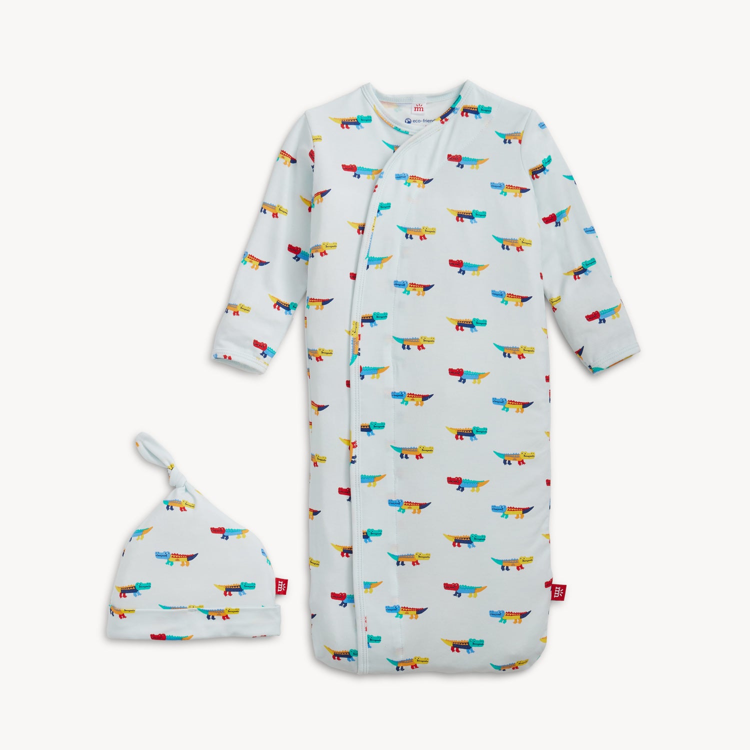 A cozy sleeper gown and matching knotted hat set in light blue with an all-over print of colorful, stylized crocodiles, by Magnetic Me.