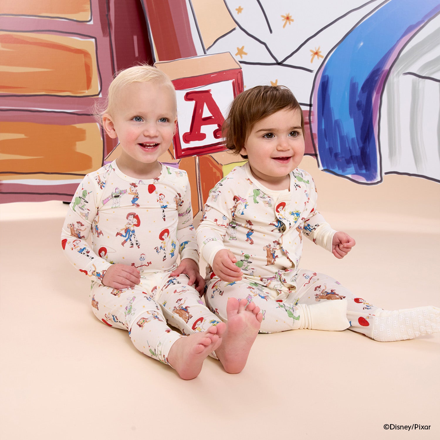 Two children wearing matching Toy Story nightwear, by Magnetic Me.