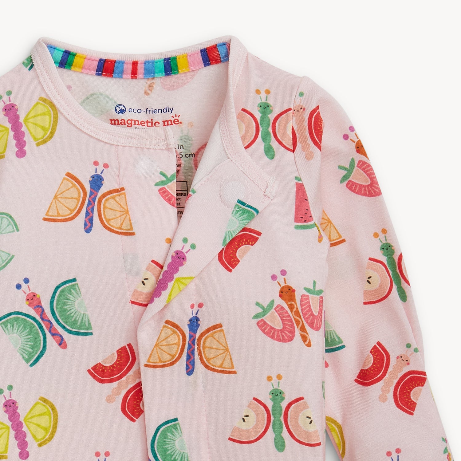 Open magnet of A light pink long-sleeve footie featuring an all-over print of colorful butterflies with fruit-slice wings, by Magnetic Me.