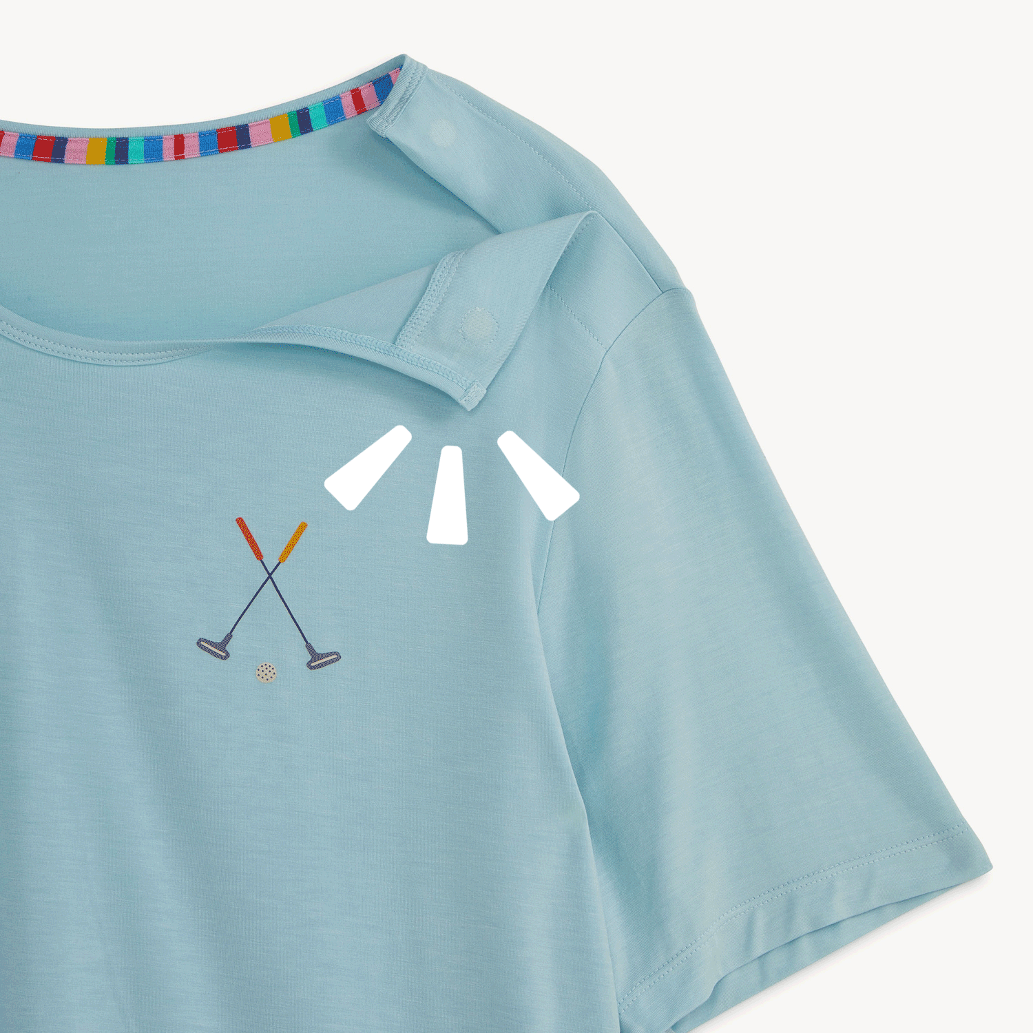 Open and close magnet on the shoulder in A two-piece adult pajama set featuring a solid light blue short-sleeve t-shirt with a small golf club chest detail and matching patterned long pants, by Magnetic Me.