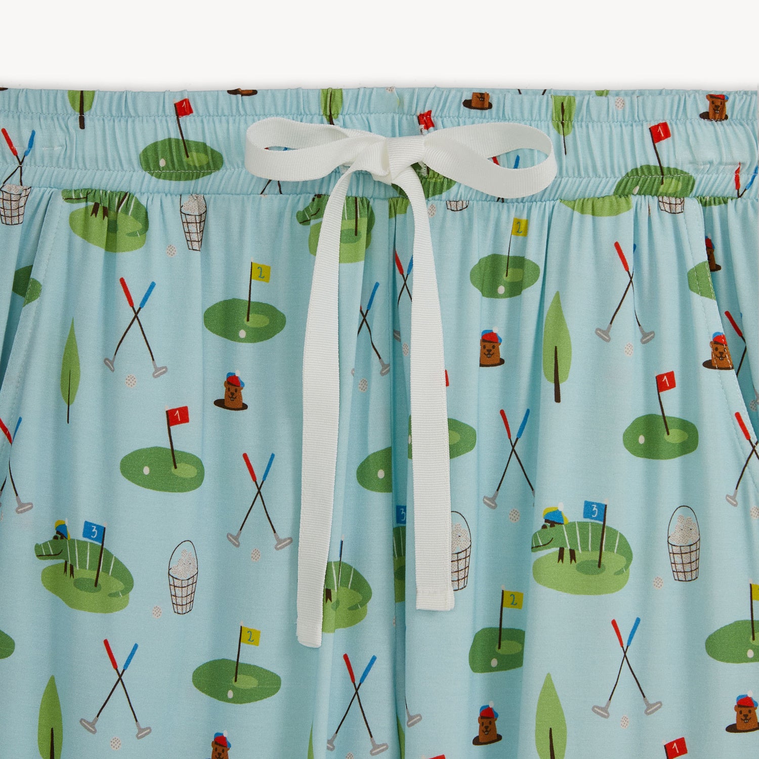 pant close up with golf-themed pattern on a blue background, by Magnetic Me.