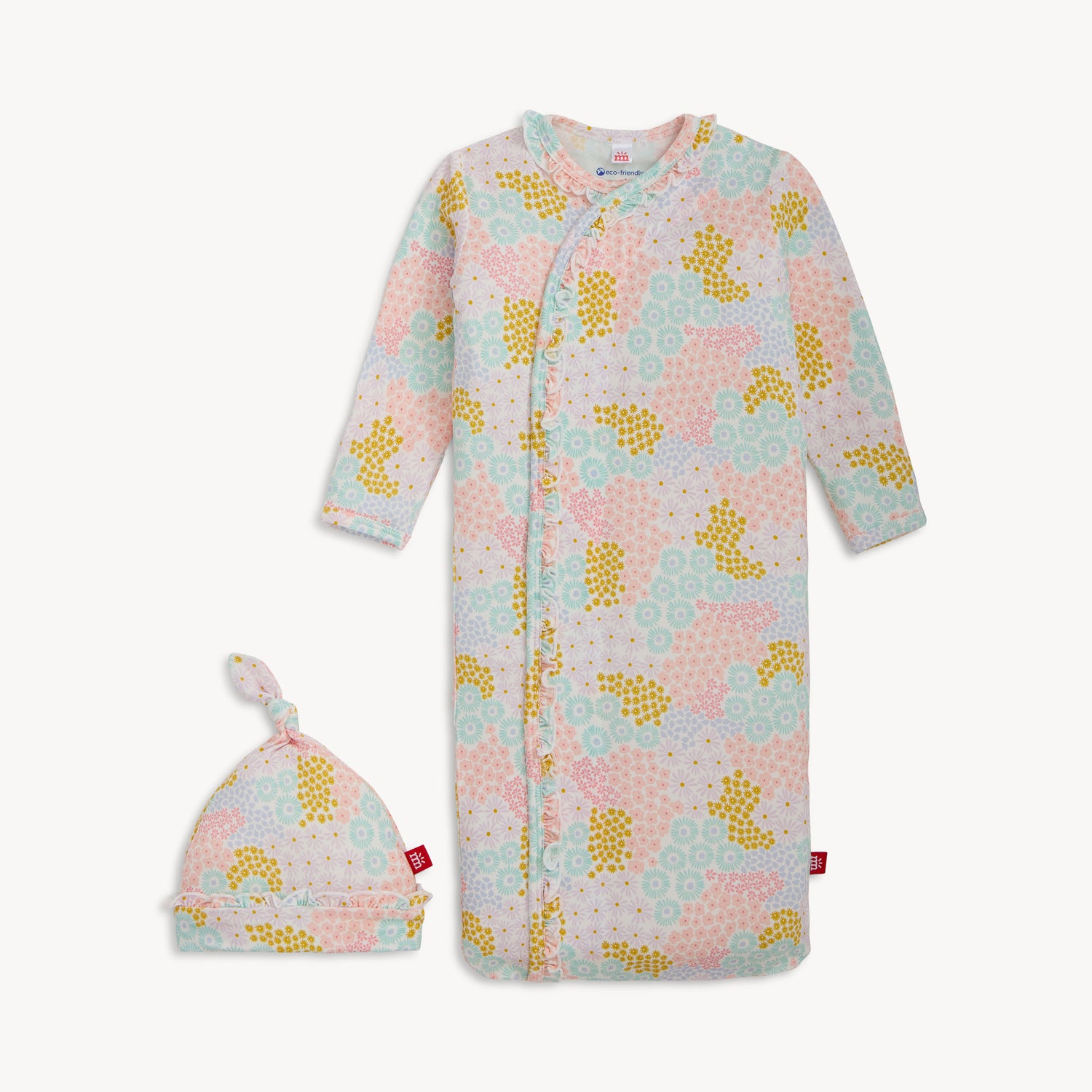 A long-sleeve infant sleeper gown and matching knotted hat with ruffle trim in a pastel meadow flower print, by Magnetic Me.